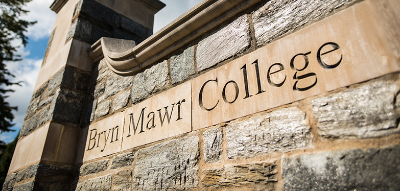 stone wall with college name